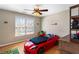 Fun ' bedroom featuring a car-shaped bed, hardwood floors, and a ceiling fan for a playful atmosphere at 4048 Sandy Branch Ne Dr, Buford, GA 30519