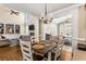 Open concept dining area features hardwood floors, bright natural light, and modern chandelier at 4048 Sandy Branch Ne Dr, Buford, GA 30519