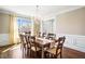 Elegant dining room with a crystal chandelier and large windows, with seating for ten at 4048 Sandy Branch Ne Dr, Buford, GA 30519