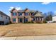 Beautiful brick two-story home with manicured lawn and symmetrical window placement at 4048 Sandy Branch Ne Dr, Buford, GA 30519