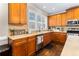 Charming kitchen featuring wood cabinets, a stainless steel dishwasher, and natural light at 4048 Sandy Branch Ne Dr, Buford, GA 30519