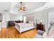 Hardwood floors, lots of natural light, and a tray ceiling are just a few of the features in the main bedroom at 4048 Sandy Branch Ne Dr, Buford, GA 30519