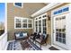 Inviting covered porch with neutral furniture, decorative rug, and bright natural light at 4048 Sandy Branch Ne Dr, Buford, GA 30519