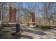 Community entrance with brick columns and iron archway surrounded by trees at 4283 Brighton Nw Way, Kennesaw, GA 30144