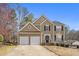 Charming two-story home featuring a well-manicured front yard, two-car garage, and classic architectural details at 4283 Brighton Nw Way, Kennesaw, GA 30144