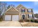 Charming two-story home featuring a well-manicured front yard, two-car garage, and classic architectural details at 4283 Brighton Nw Way, Kennesaw, GA 30144