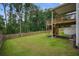 Expansive backyard featuring a lush lawn, wooden fence, and a raised wooden deck with steps at 66 Snowdon Way, Villa Rica, GA 30180