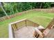 Large backyard with a well-maintained lawn, framed by a wooden fence, and accessible stairs at 66 Snowdon Way, Villa Rica, GA 30180