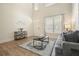 Inviting living room with hardwood floors, a comfortable grey sofa, and lots of natural light at 66 Snowdon Way, Villa Rica, GA 30180