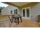 Covered back patio with wood floors and cozy seating area offers a relaxing outdoor space at 66 Snowdon Way, Villa Rica, GA 30180