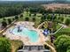 Aerial view of community pool area with lounge chairs, umbrellas, waterslide, and splash area at 66 Snowdon Way, Villa Rica, GA 30180