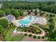 Aerial view of community pool, clubhouse, and park with walking paths in a wooded neighborhood at 66 Snowdon Way, Villa Rica, GA 30180