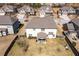 Aerial view of the backyard featuring a covered patio and manicured lawn at 2401 Day Break Way, Dacula, GA 30019