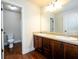 Bathroom features double sink vanity with dark cabinets, granite countertop, and modern fixtures at 2401 Day Break Way, Dacula, GA 30019