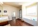 Bright bathroom featuring a soaking tub, separate shower, and granite countertops at 2401 Day Break Way, Dacula, GA 30019