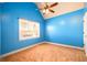 Bright bedroom with blue walls, fan, and large window at 2401 Day Break Way, Dacula, GA 30019