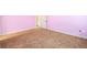 Spacious bedroom featuring plush brown carpeting and soothing light pink walls at 2401 Day Break Way, Dacula, GA 30019