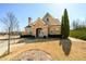 Charming brick clubhouse featuring an arched entrance, well-manicured landscaping, and beautiful trees at 2401 Day Break Way, Dacula, GA 30019