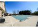 Large community pool covered for the off-season, with clubhouse in the background, clear blue sky at 2401 Day Break Way, Dacula, GA 30019