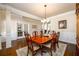 Spacious dining room with a formal table, crown molding, and elegant lighting at 2401 Day Break Way, Dacula, GA 30019