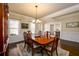 Traditional dining room with a wood table and matching chairs, chandelier, and hardwood flooring at 2401 Day Break Way, Dacula, GA 30019