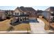 Handsome two-story brick home featuring a welcoming front porch and attached two-car garage at 2401 Day Break Way, Dacula, GA 30019