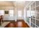 Bright entryway with hardwood floors, wainscoting, and a view into adjacent living spaces at 2401 Day Break Way, Dacula, GA 30019