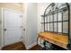 Hallway with a dark metal shelving unit and wooden accents next to a white paneled door at 2401 Day Break Way, Dacula, GA 30019