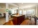 Open-concept kitchen with a granite island, stainless steel sink, and dark wood cabinetry at 2401 Day Break Way, Dacula, GA 30019