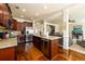 Spacious kitchen with granite counters, dark wood cabinets, and a view of the adjoining living room at 2401 Day Break Way, Dacula, GA 30019