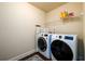 Laundry room with modern, front-load washer and dryer units at 2401 Day Break Way, Dacula, GA 30019