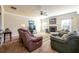 Cozy living room with plush seating, a stone fireplace, and natural light from surrounding windows at 2401 Day Break Way, Dacula, GA 30019