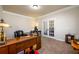 Large carpeted office space featuring a desk, french doors, and neutral colored walls at 2401 Day Break Way, Dacula, GA 30019