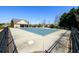 Community pool with a safety cover sits next to the pool house with beautiful trees surrounding the area at 2401 Day Break Way, Dacula, GA 30019