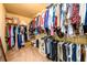 Walk-in closet with organized shelving and hanging rods filled with clothes at 2401 Day Break Way, Dacula, GA 30019