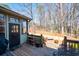 View of the deck with outdoor seating, a stone patio, and a fenced-in yard at 5034 Kingsbridge Pass, Powder Springs, GA 30127