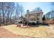 Exterior view of home with large yard, patio, and mature trees at 5034 Kingsbridge Pass, Powder Springs, GA 30127