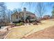 Exterior view of home with a large yard, patio and mature landscaping at 5034 Kingsbridge Pass, Powder Springs, GA 30127