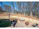 Spacious backyard with a patio, built-in grill, playground, and mature trees at 5034 Kingsbridge Pass, Powder Springs, GA 30127