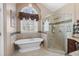 Luxurious bathroom featuring a soaking tub, glass-enclosed shower, and elegant tile work at 5034 Kingsbridge Pass, Powder Springs, GA 30127