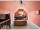 Cozy bedroom with a pitched ceiling, light and neutral decor, and bright orange walls at 5034 Kingsbridge Pass, Powder Springs, GA 30127