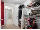 Well-organized closet with shelves, hanging rods, and access to the laundry area and bathroom at 5034 Kingsbridge Pass, Powder Springs, GA 30127