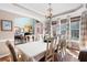 Light-filled dining area with hardwood flooring, stylish chandelier, and scenic outdoor views at 5034 Kingsbridge Pass, Powder Springs, GA 30127