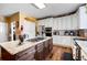 Modern kitchen featuring stainless steel appliances, granite countertops, and kitchen island at 5034 Kingsbridge Pass, Powder Springs, GA 30127