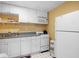 Kitchen area with white appliances and cabinetry in a bright space at 5034 Kingsbridge Pass, Powder Springs, GA 30127