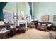 Cozy living room showcasing fireplace, hardwood floors, comfortable seating, and large windows at 5034 Kingsbridge Pass, Powder Springs, GA 30127