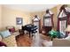 Cozy living room featuring a grand piano, comfortable seating, and abundant natural light at 5034 Kingsbridge Pass, Powder Springs, GA 30127