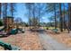 Community playground with climbing structure, slides, and seating near a walking path at 5034 Kingsbridge Pass, Powder Springs, GA 30127