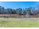 A tranquil pond with a fountain, surrounded by lush greenery and a walking path at 5034 Kingsbridge Pass, Powder Springs, GA 30127