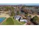 Aerial shot of a home with tennis court, lake access, beautiful trees, and lush landscaping at 5690 Rutland Trce, Lithonia, GA 30058